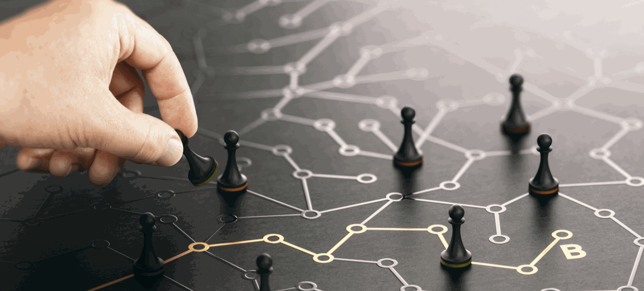 A hand moves chess pieces strategically